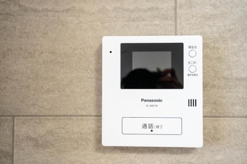 a white remote control on a tile wall at Flex cella satozuka - Vacation STAY 17763 in Sapporo