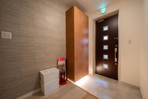 a bathroom with a fire hydrant next to a door at Flex cella satozuka - Vacation STAY 17763 in Sapporo