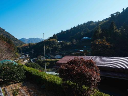 a view of a mountain with a building and trees at Shirataki no yado - Vacation STAY 29763v in Higashimiyoshi