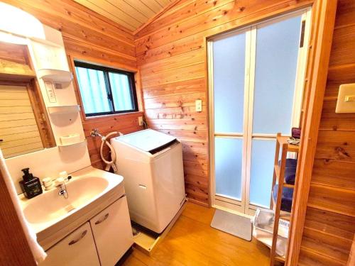 a bathroom with a white refrigerator and a sink at Makino MeguRia - Vacation STAY 32791v in Takashima