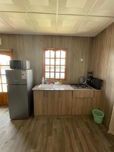a kitchen with a refrigerator and a counter top at Camping Riad Maissa in Dou Tourga