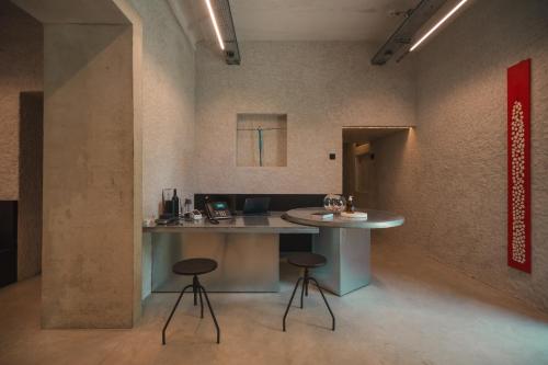 a kitchen with a table and stools in a room at B5 Boutique & Design Hotel - Digital Check in - Adults Only in Lugano