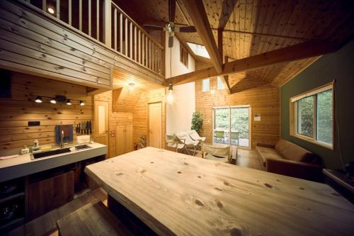 a kitchen and living room with a large wooden table at Moriterasu Rin - Vacation STAY 38771v in Ōkuwa