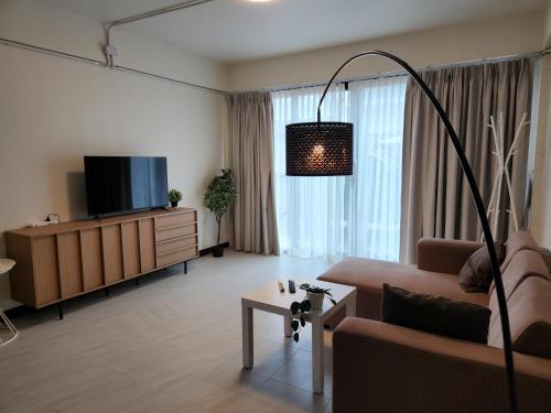 a living room with a couch and a tv at phanganchai in Thongsala
