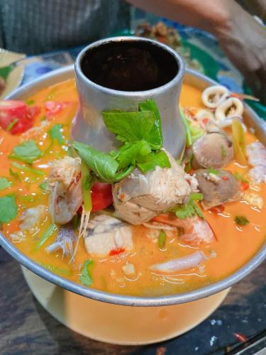 a plate of soup with a cup on top of it at Wangsarai Resort and Restaurant วังสาหร่าย รีสอร์ต และ ร้านอาหาร in Don Sak