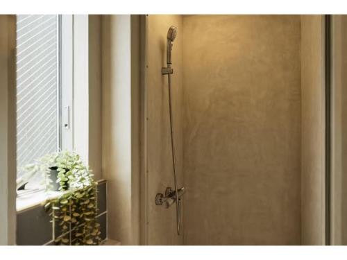 a door with a shower in a room with a window at &SUN mini mini - Vacation STAY 17824 in Yokosuka