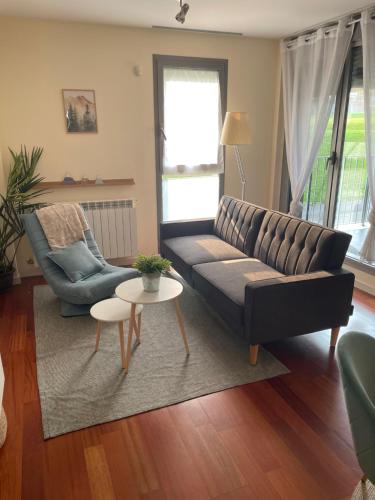 a living room with a couch and a table at Atalaya Peña Telera Margas Golf in Sabiñánigo