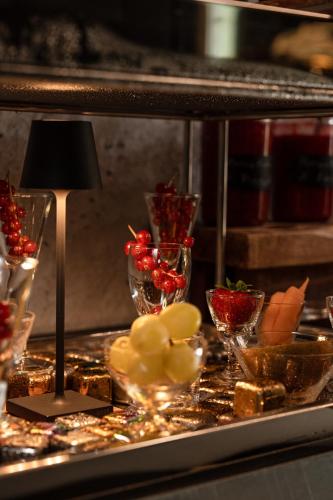 a buffet with glasses of fruit and vegetables on a table at B5 Boutique & Design Hotel - Digital Check in - Adults Only in Lugano