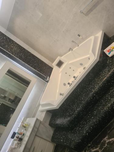 a white sink sitting on top of a staircase at Business Apart Arkadia in Odesa