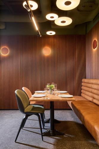 a dining room with a wooden table and chairs at Wroclaw Hotel in Wrocław
