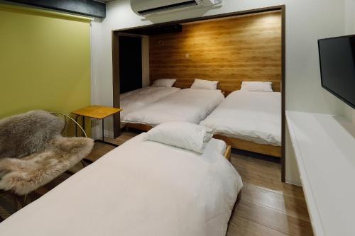 a room with three beds and a mirror at Utopia 21 - Vacation STAY 17955 in Sapporo