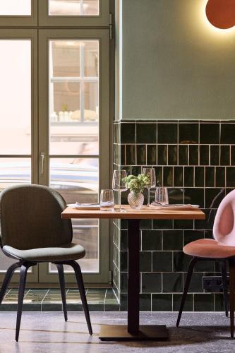 a table and two chairs in a room at Wroclaw Hotel in Wrocław