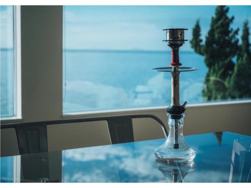a glass table with a candle on top of it at Viila NO°00 - Vacation STAY 34231v in Awaji