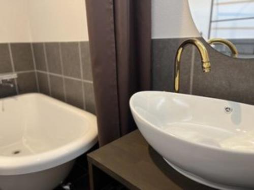 a bathroom with a white sink and a tub at Onomichi Villa Ayah - Vacation STAY 53618v in Onomichi