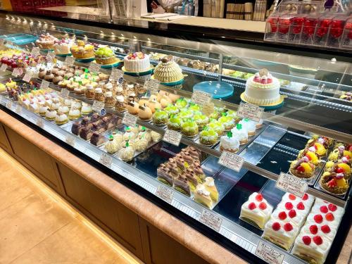 a display case filled with different types of desserts at Chigasaki JH Court C - Vacation STAY 17903 in Chigasaki