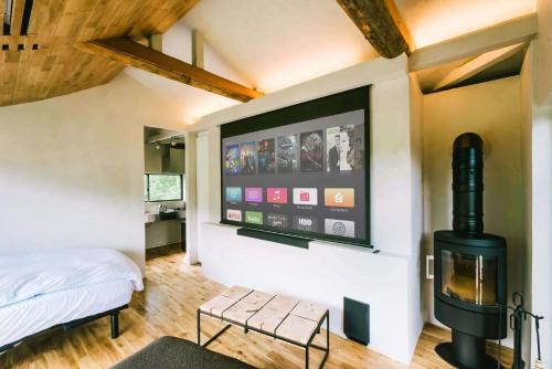 a bedroom with a fireplace and a tv on the wall at THEATER 1 - Vacation STAY 40857v in Motojuku