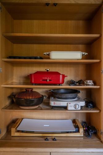 a cabinet filled with various kitchen utensils at Private Inn Kazu - Vacation STAY 56401v in Abuta