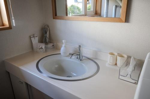 a bathroom counter with a sink and a mirror at Private Inn Kazu - Vacation STAY 56401v in Abuta