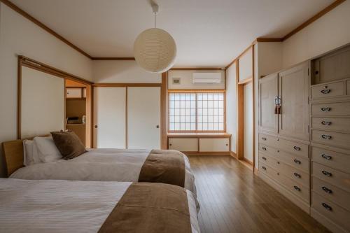 a bedroom with a bed and a window in it at Private Inn Kazu - Vacation STAY 56401v in Abuta
