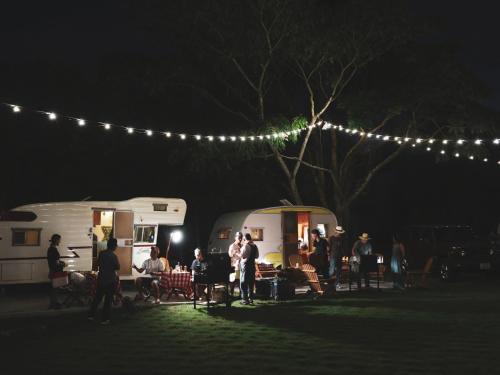 a group of people standing next to rvs at night at Beverly Glamping - Vacation STAY 82305v in Kakegawa