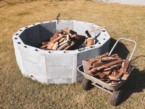 a container of wood sitting on the grass next to a cart at Beverly Glamping - Vacation STAY 82305v in Kakegawa