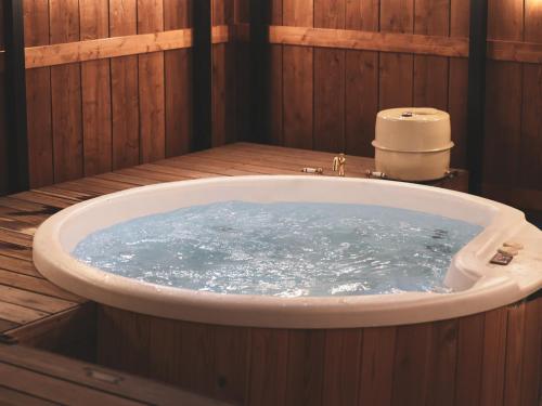 a bath tub filled with water in a wooden bathroom at Beverly Glamping - Vacation STAY 82305v in Kakegawa
