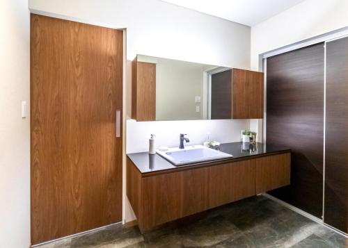 a bathroom with a sink and a mirror at villa-rizo Yamada - Vacation STAY 47919v in Takayama