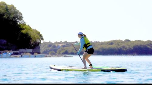 a woman on a paddle board in the water at UMILABO - Vacation STAY 64339v in Shima