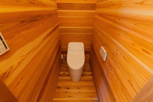 a toilet in a small room with wood paneling at UMILABO - Vacation STAY 64339v in Shima