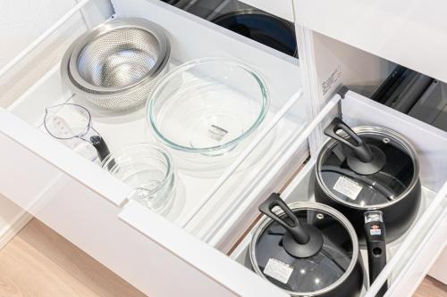 a kitchen drawer with two pans and a strainer at UMICHIKA 6886 - Vacation STAY 64201v in Ichinomiya