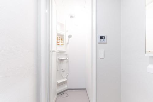 a white bathroom with a shower and a toilet at Grandioso Okinawa Pool Villa 8 - Vacation STAY 51219v in Onna