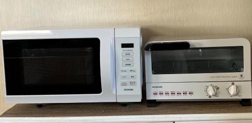 two microwaves sitting next to each other on a counter at Mori no hoshi - Vacation STAY 65135v in Kunigami