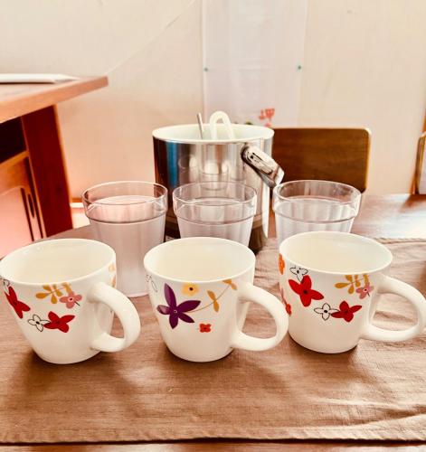 a table with four coffee mugs and glasses on it at Mori no hoshi - Vacation STAY 65135v in Kunigami