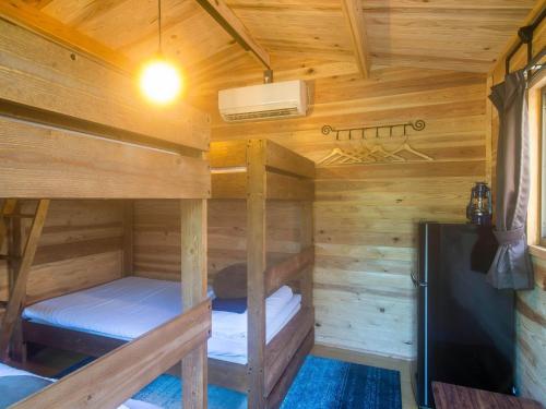 a log cabin with two bunk beds and a refrigerator at dejavu - Vacation STAY 56317v in Manazuru