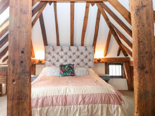 a bedroom with a bed in a attic at West Lodge in Ashford