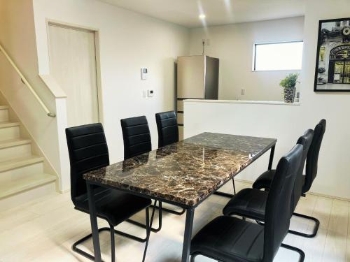 a dining room with a table and black chairs at Building A - Vacation STAY 72722v in Kikuchi