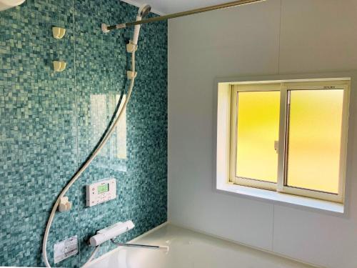 a bathroom with a shower and a sink with a mirror at Building A - Vacation STAY 72722v in Kikuchi