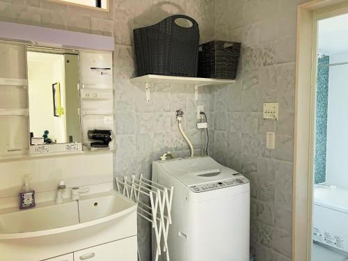 a small bathroom with a washer and dryer in it at Building A - Vacation STAY 72722v in Kikuchi