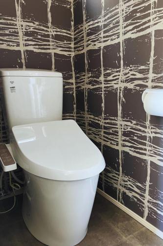 a white toilet in a bathroom with a black wall at Building A - Vacation STAY 72722v in Kikuchi