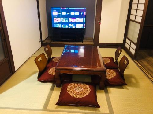 a table and chairs with a television in a room at shiamoterrace - Vacation STAY 18088 in Odawara