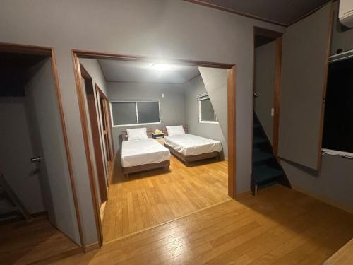 a small room with two beds and a hallway at Takaoka - House - Vacation STAY 18350 in Takaoka