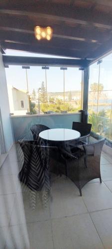 a table and chairs in a room with a window at Casa do Mar - Luxurious Villa with Swim Spa & sea view in Luz