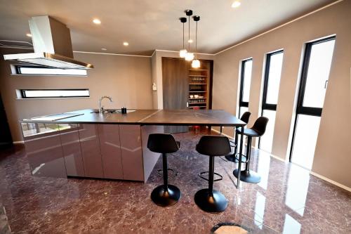 a kitchen with a large island with stools at 8Room - Vacation STAY 70870v in Yachimata