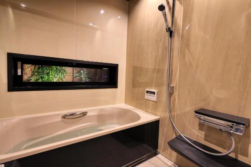 a bathroom with a bath tub and a shower at Kazekuru - Vacation STAY 18924 in Fujiyoshida