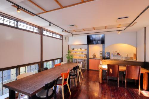 a dining room with a large wooden table and chairs at Kazekuru - Vacation STAY 18924 in Fujiyoshida
