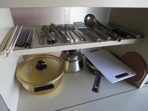 a kitchen counter with a shelf with utensils at Hitachiota Studio - Vacation STAY 18131 in Hitachi Ota