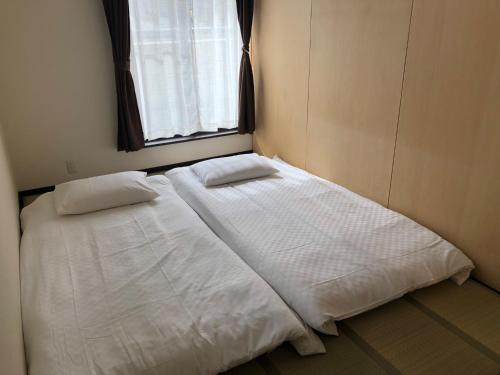 a bed in a small room with a window at Kyoto - House - Vacation STAY 18133 in Iwakura