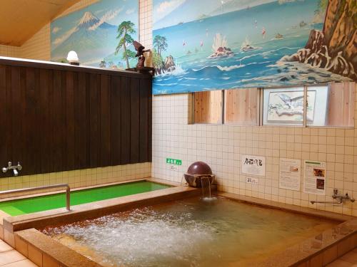 a large pool of water in a bathroom with a pool at Hida Town House Grass - Vacation STAY 77084v in Takayama