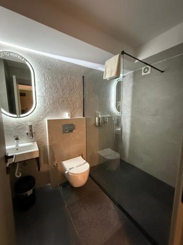 a bathroom with a toilet and a sink and a shower at OTTO X Hotel in Kavaklıdere