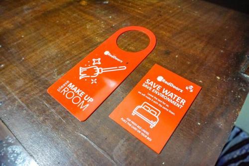 an orange pair of scissors sitting on top of a table at RedDoorz near Penimbangan Beach Singaraja in Singaraja